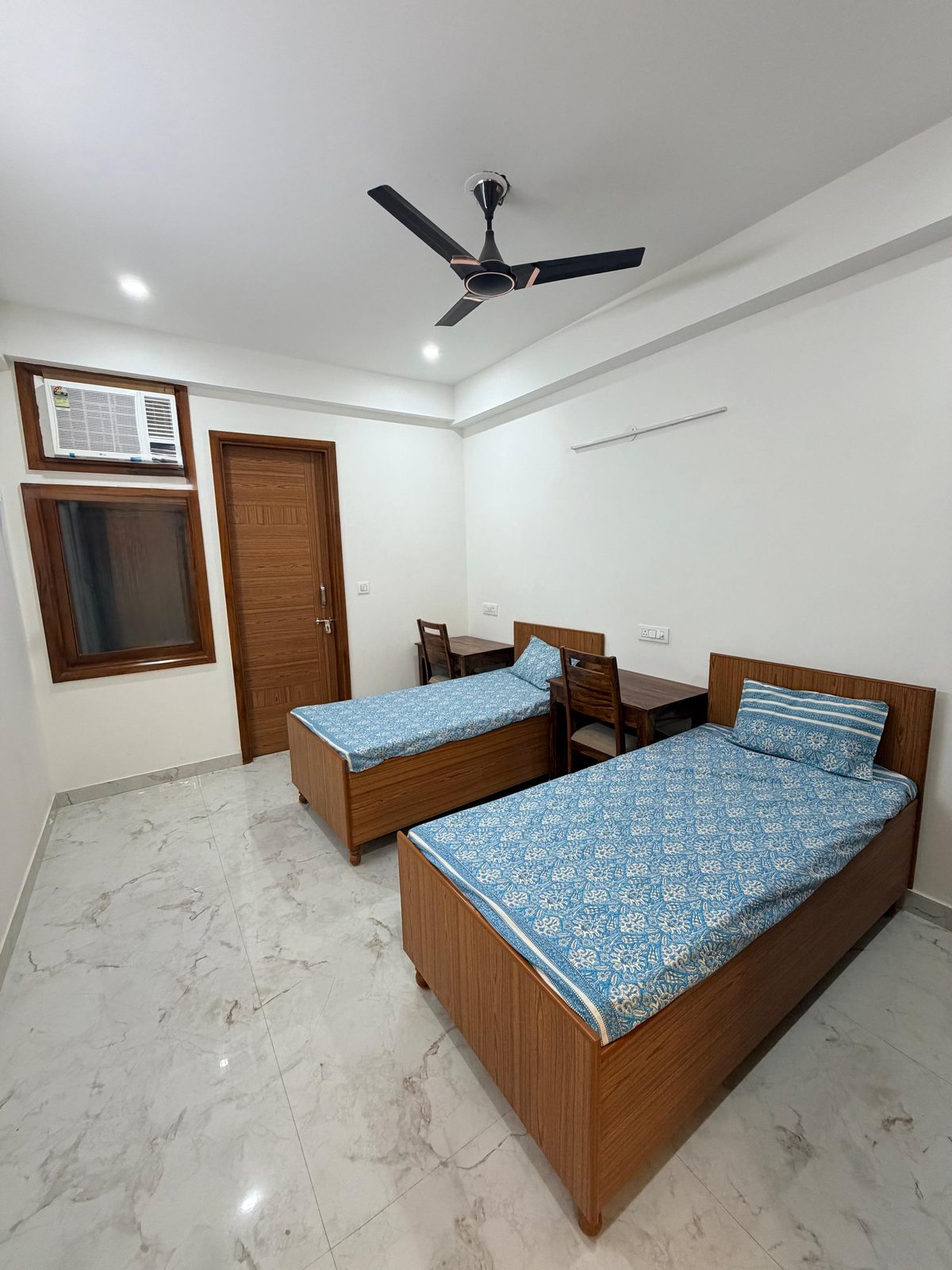 Twin-sharing room with study desks at Tri-Homes L-10