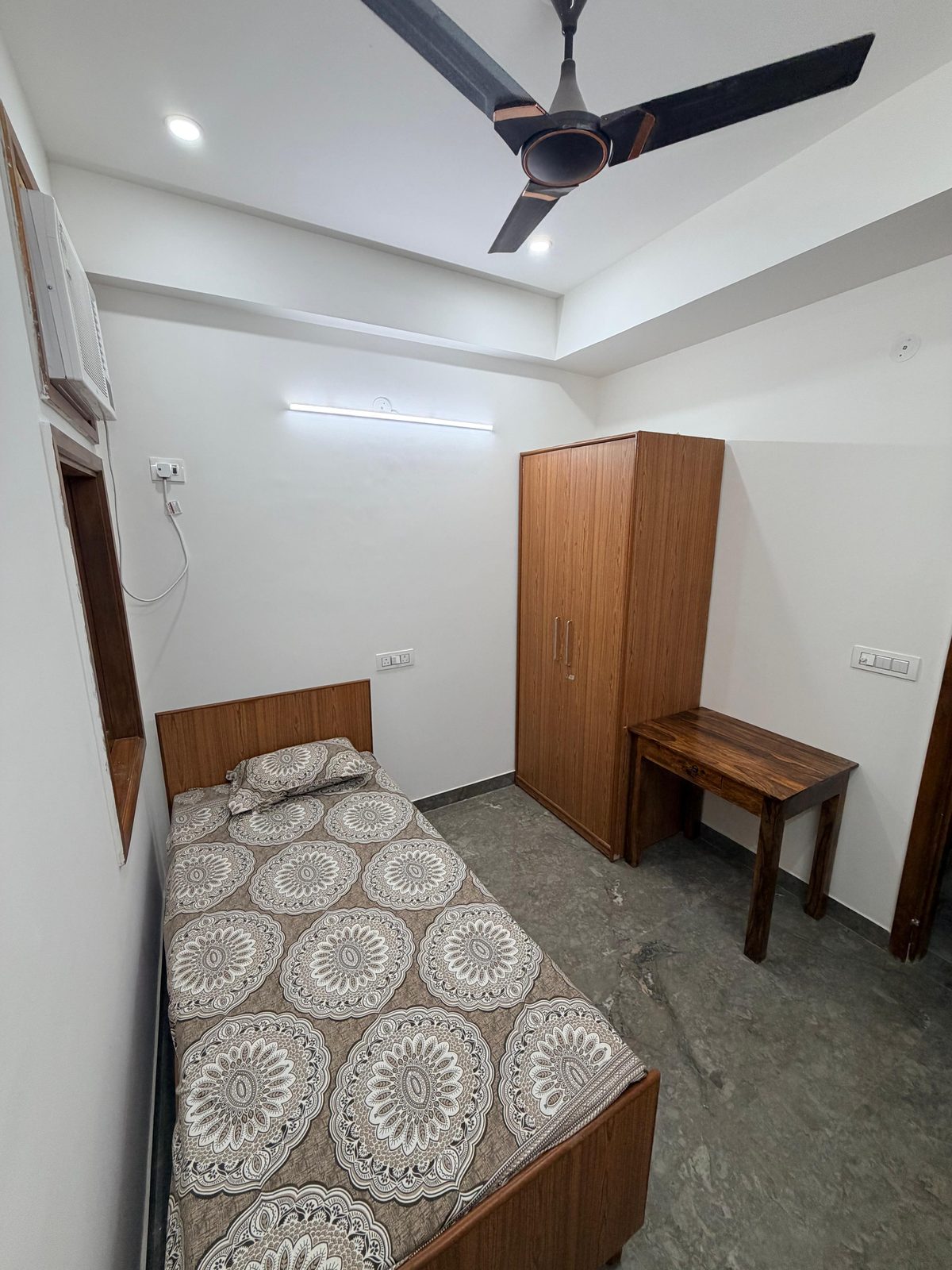 Single room with wardrobe and study table at Tri-Homes L-10