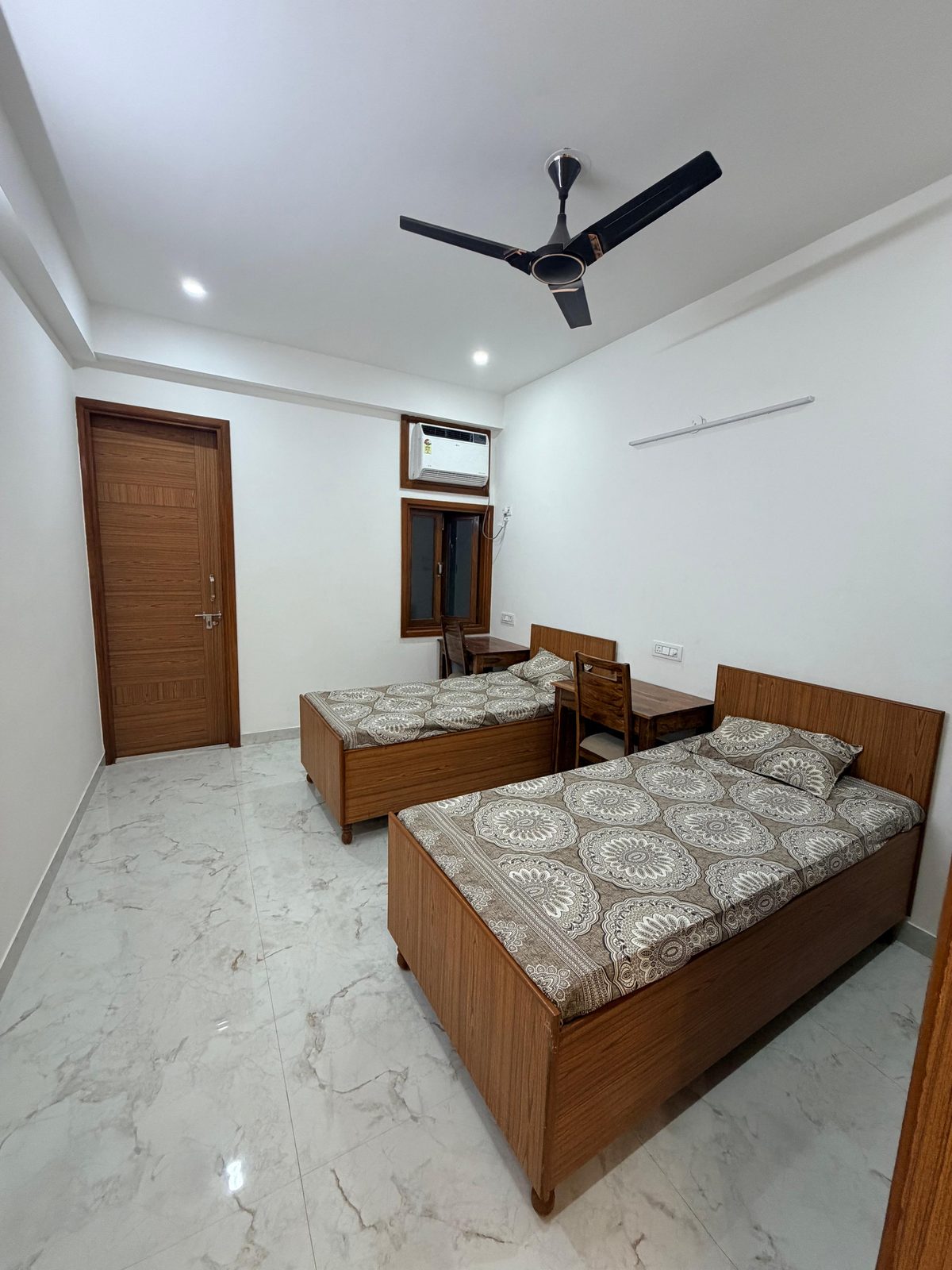 Twin beds with fresh linen at Tri-Homes L-10